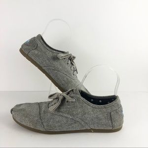 Tom’s grey lace up tennis shoes